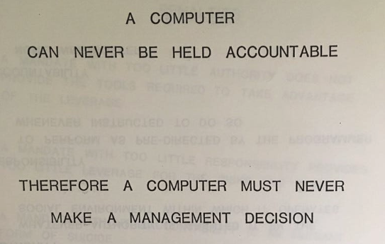 A printed slide with all-caps text reading 
