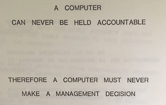 A printed slide with all-caps text reading 