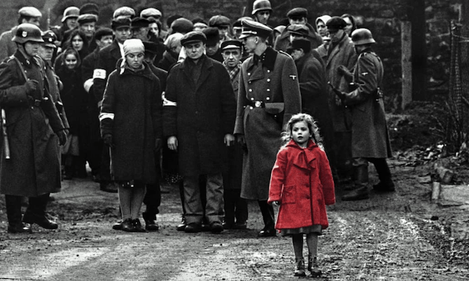 A movie still from Schindler’s List showing a little girl in a red coat against the black-and-white backdrop of soldiers and prisoners.