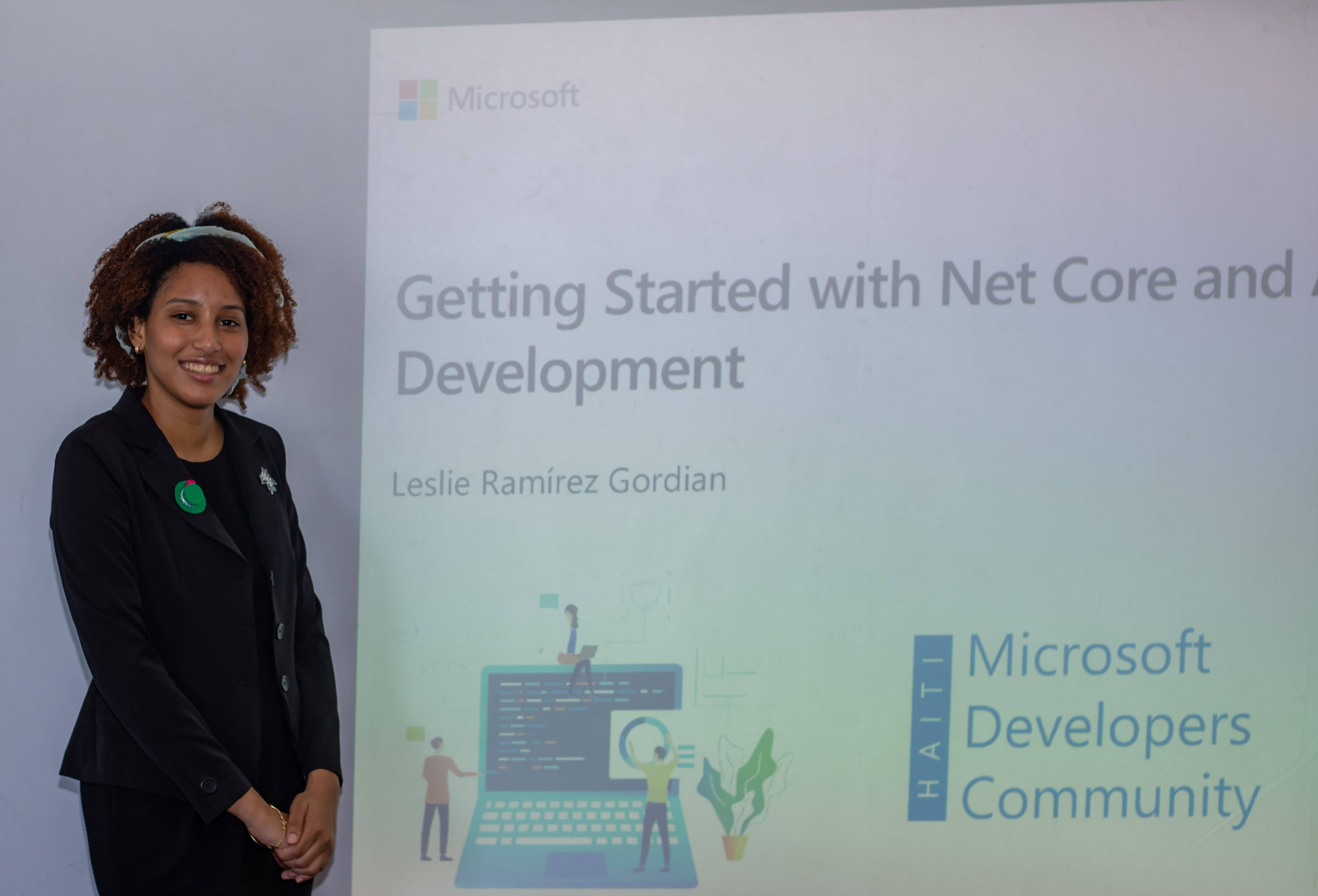 Leslie Ramirez in front of a slideshow with 'Getting Started with .NET Core...' Microsoft Developers Community Haiti