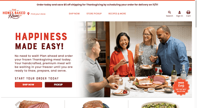 The Honey Baked Ham Co. is advertising its frozen Thanksgiving meals on its website in October 2021. The hero image says “Happiness Made Easy” and gives visitors the option to “Ship Now” or “Pickup” their order.