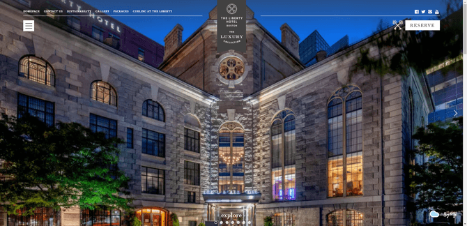 A screenshot from the top of the home page for the Liberty Hotel website. The background image is from the entrance to the hotel. There are subtle nods to its history — like the icon of the two keys crossed over one another in the top-right corner next to the “Reserve” button.