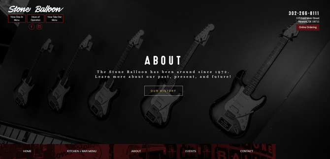 A screenshot from the Stone Balloon Ale House website and About page. There’s a  background photo of guitars mounted on a wall with a dark overlay. The text on top of it says: “About: The Stone Balloon has been around since 1972. Learn more about our past, present and future!” There’s a button beneath that says “Out History”.