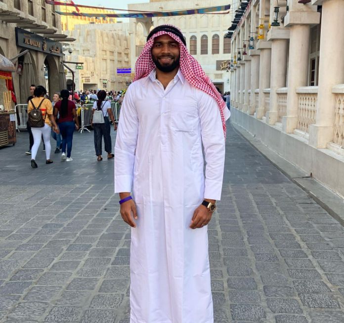 Smiling man standing in a public space