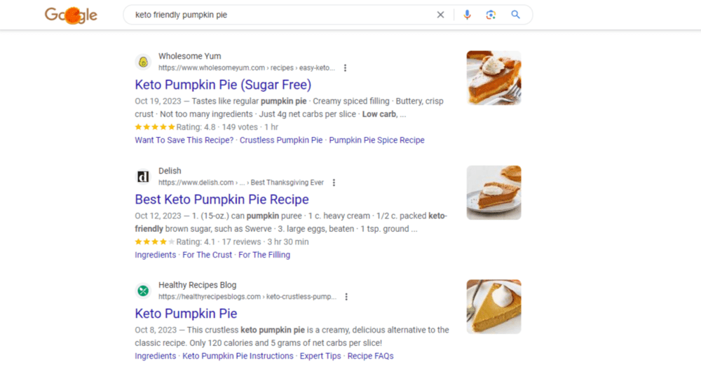 Favicons appear next to websites in this Google search result for “keto friendly pumpkin pie”. We see an avocado favicon for Wholesome Yum, a white “d” on a black background for Delish, and a crossed fork and spoon against a green background for the Healthy Recipes Blog.