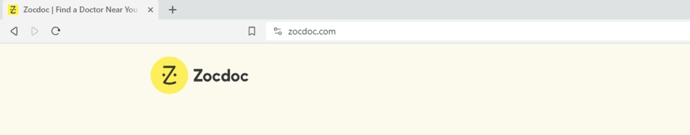 In the browser tab, we see the circular yellow “Z” favicon for Zocdoc. There are two dots on each side of the curved “Z” shape.