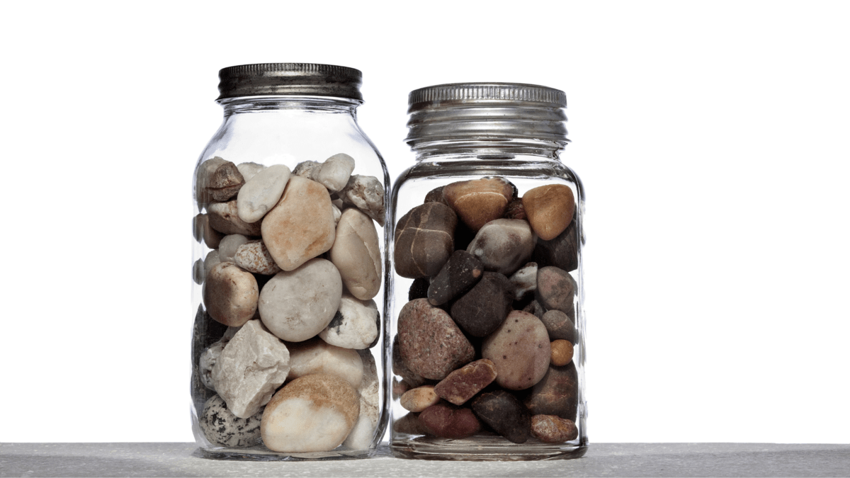 A photo of two glass jars containing big rocks and some small stones and pebbles.