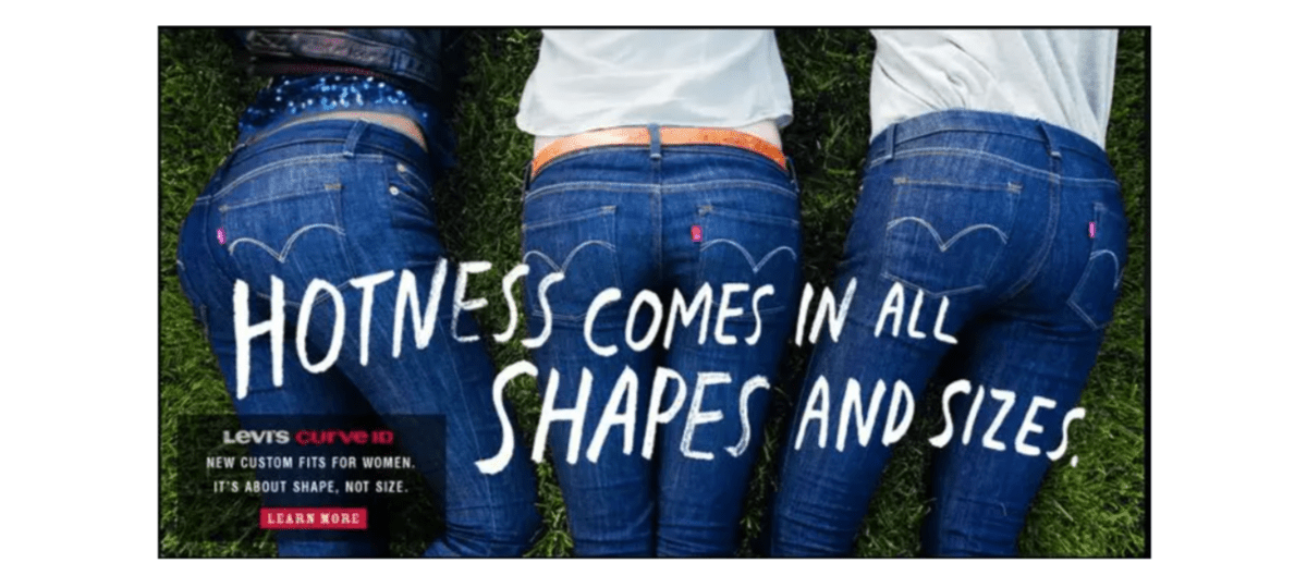A screenshot taken from a 2012 Business Insider article shows a Levi’s ad. There are three women lying on the grass, wearing a pair of Levi’s blue jeans. On top of them, it reads “Hotness Comes in All Shapes and Sizes”.