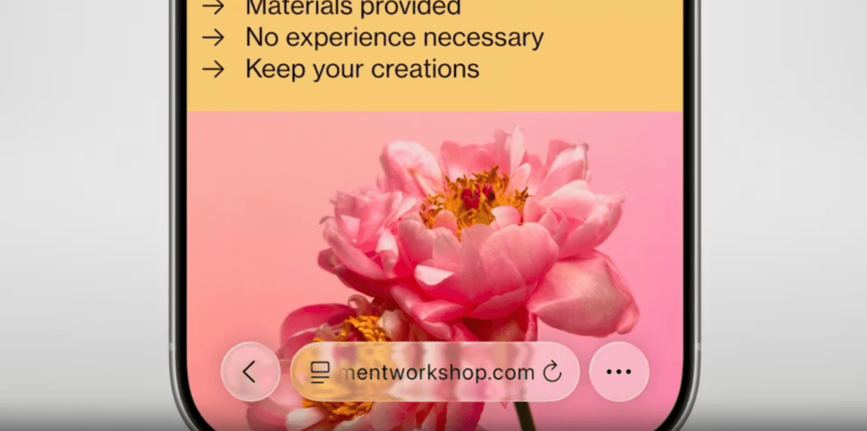When smaller Liquid Glass elements appear over content, they refract light, allowing us to see what’s behind them. In this example, we see an address bar that reads “mentworkshop.com”. Behind it, we see the pink flowers from the content background.