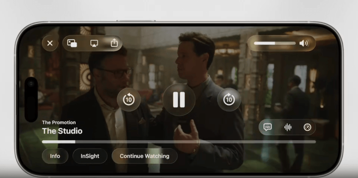 As “The Studio” plays on this video player on an iPhone, we see how different elements have been redesigned for Liquid Glass: “X” exit button, screen sharing options, volume control, video control buttons, info buttons, captions and more.