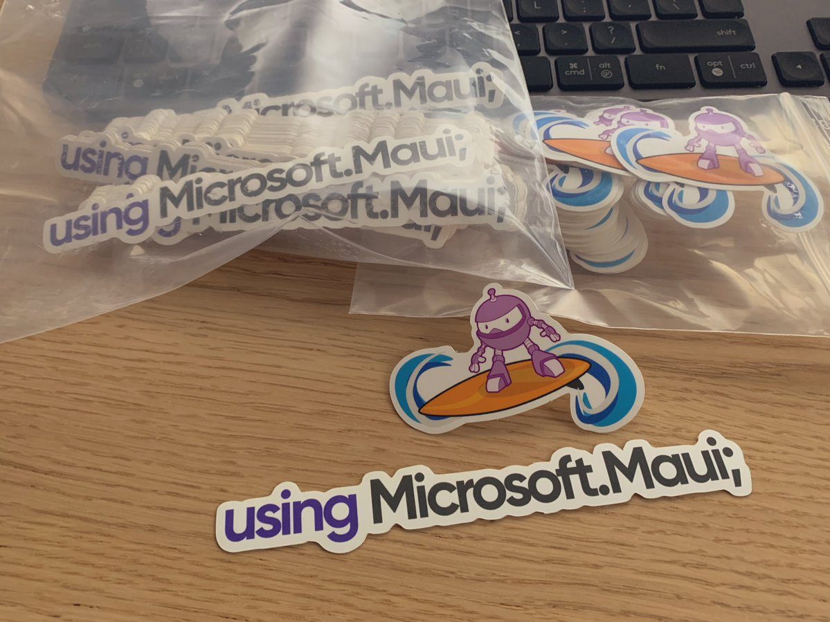 Two Maui Stickers shown in baggies: A logo of the surfer Maui robot, and 'using Microsoft.Maui;'